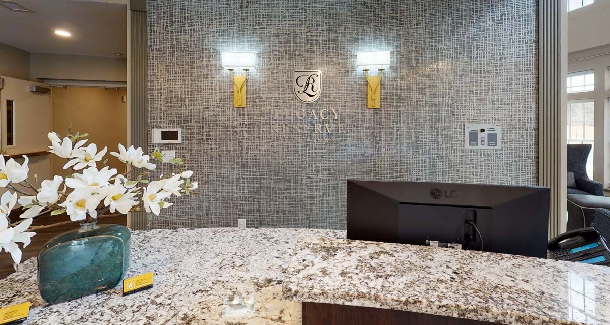 A stylish office reception area with a marble countertop and elegant lighting fixtures.