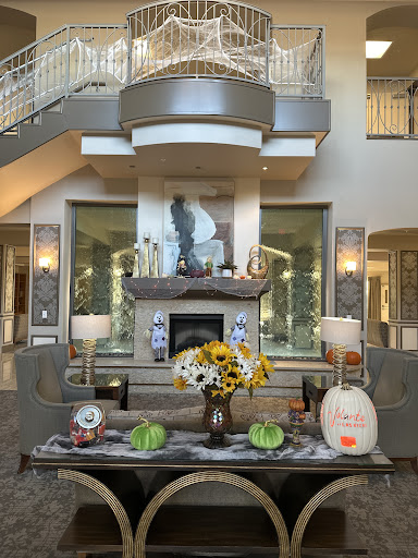 A beautifully decorated living room featuring autumn-themed decor with pumpkins and sunflowers.