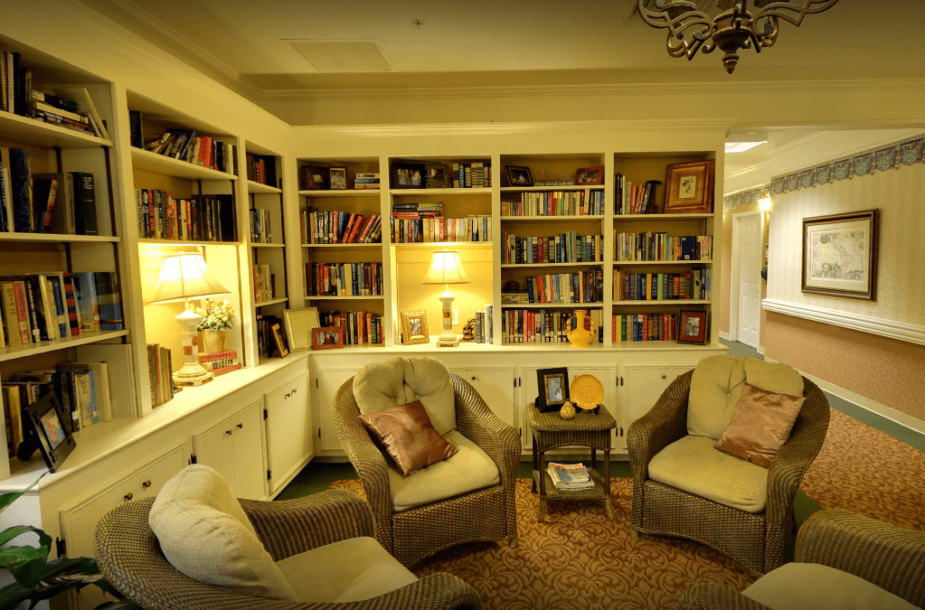 A cozy reading room with comfortable chairs and well-stocked bookshelves, creating a warm and inviting atmosphere.