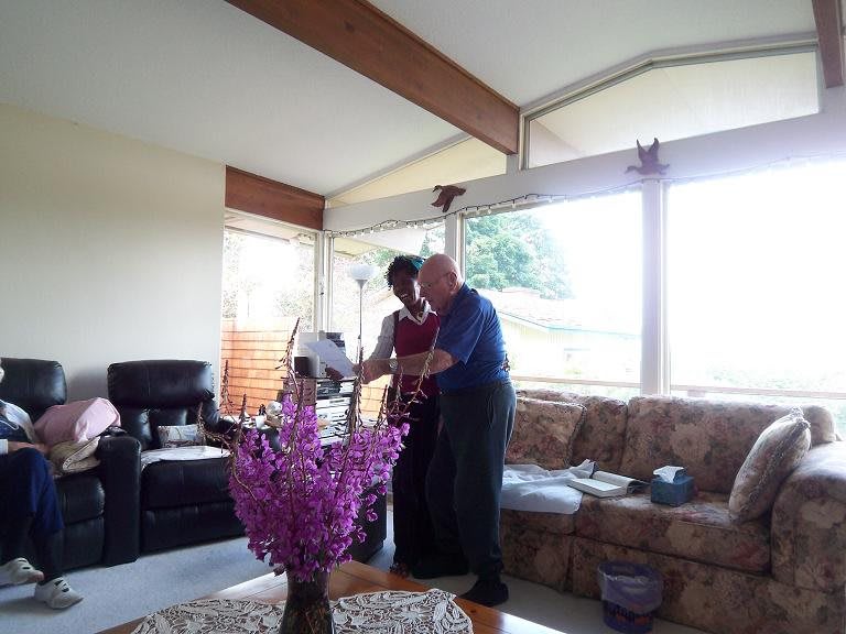 Two people interacting in a cozy living room with natural light.
