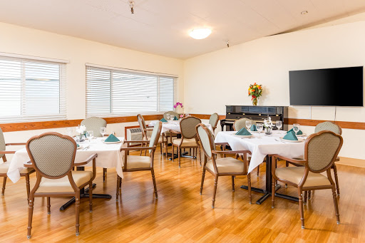 A cozy dining area set for a meal, featuring elegantly arranged tables and comfortable chairs.