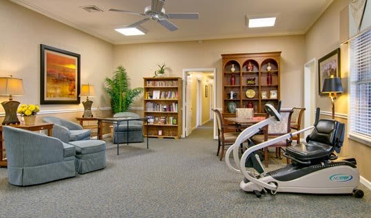 A cozy living room with comfortable seating and well-stocked bookshelves.