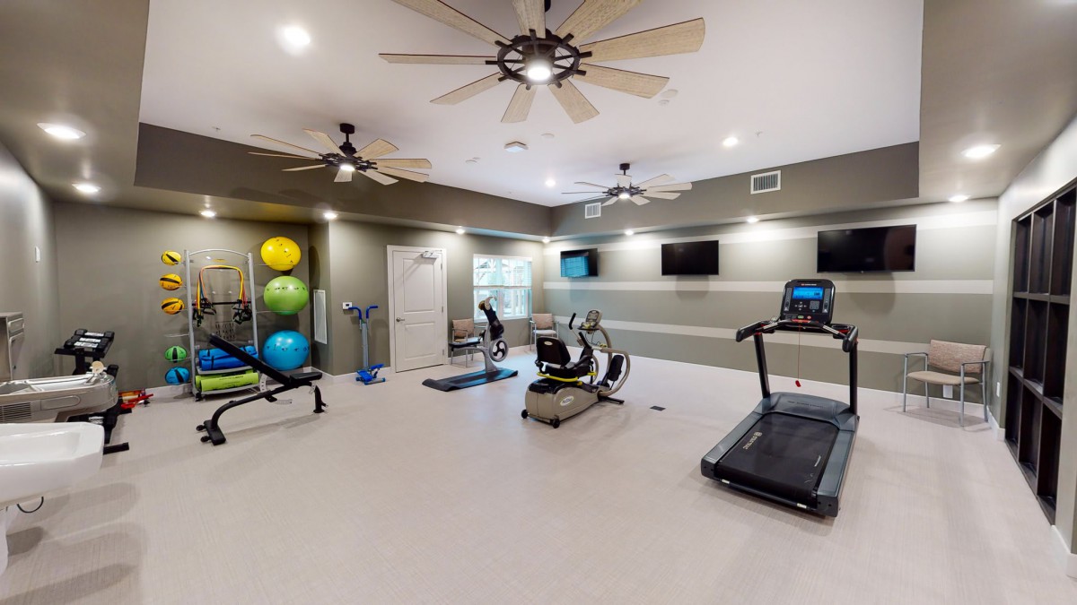 A modern gym equipped with exercise machines and a welcoming workout environment.