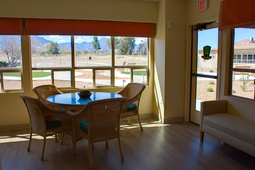 A bright dining area featuring a table and chairs with a view of the outdoors.