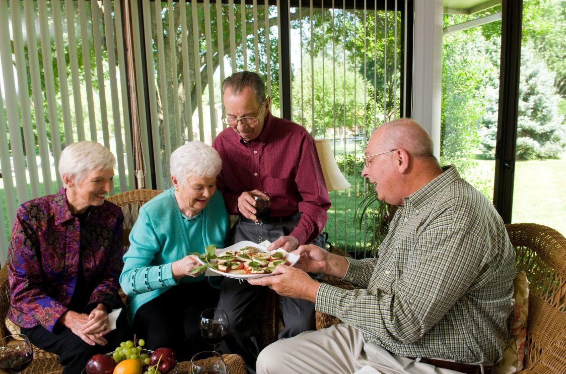 A group of seniors enjoying a meal together indoors.