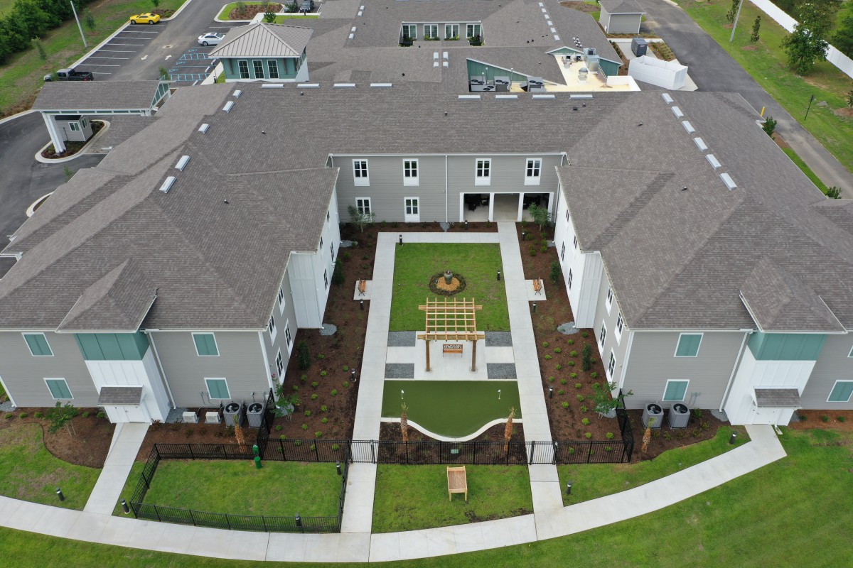 An aerial view of a residential building with a landscaped courtyard.
