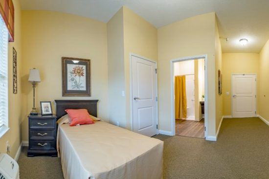 A cozy bedroom with a single bed and neutral decor.