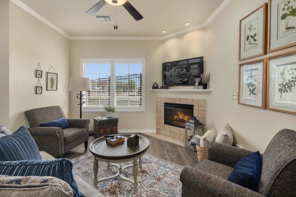 A cozy living room with a fireplace, stylish decor, and comfortable seating.