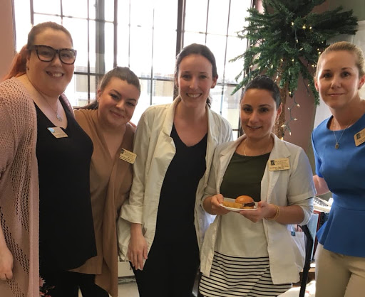 A cheerful group of women enjoying a moment together at an event.