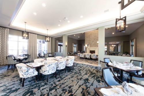 A modern restaurant dining area with stylish furniture and elegant lighting.