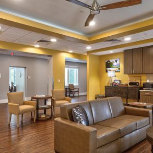 A cozy living space with modern furniture and a small kitchen area.