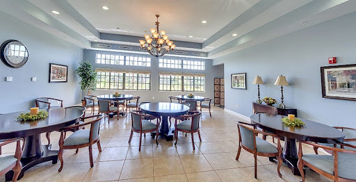 A spacious and elegantly designed dining area featuring modern furnishings and abundant natural light.