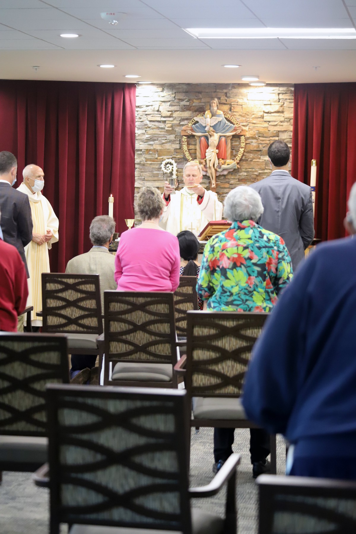 A congregation attending a church service led by a priest.