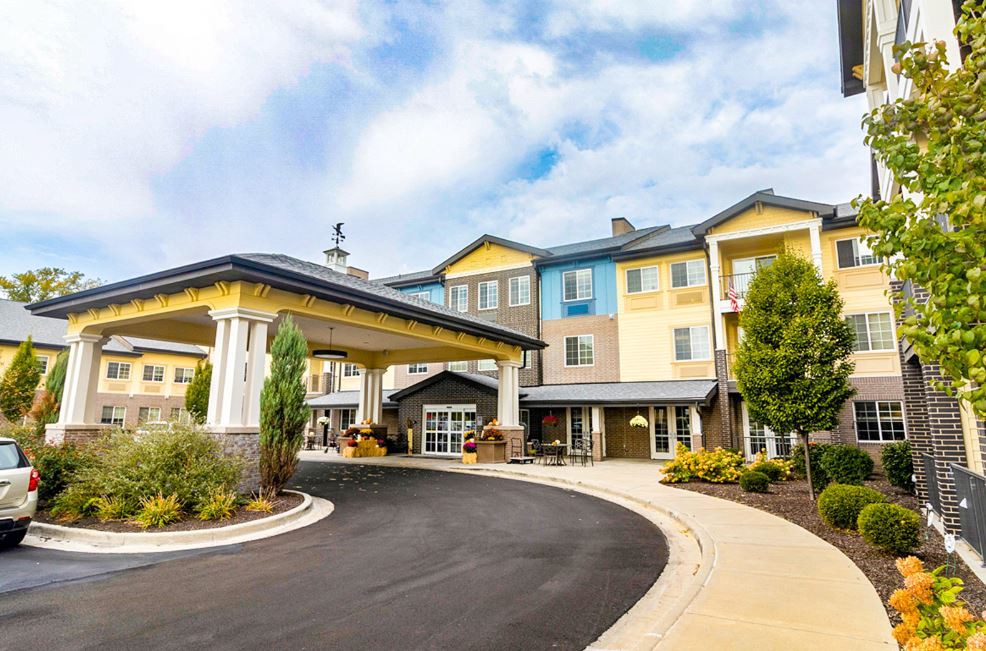 A modern hotel building with a welcoming entrance and landscaped surroundings.