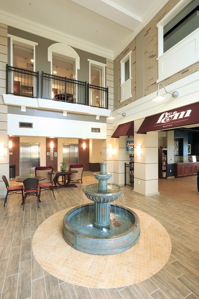 Elegant hotel lobby with a central fountain and comfortable seating.