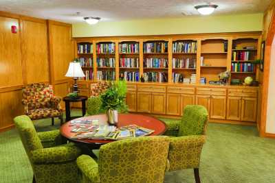 A cozy library with bookshelves and a seating area.