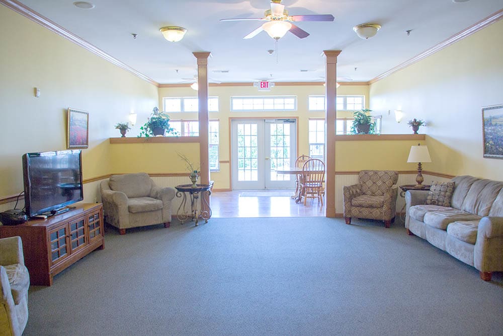 A spacious and brightly lit lobby area with comfortable seating arrangements.