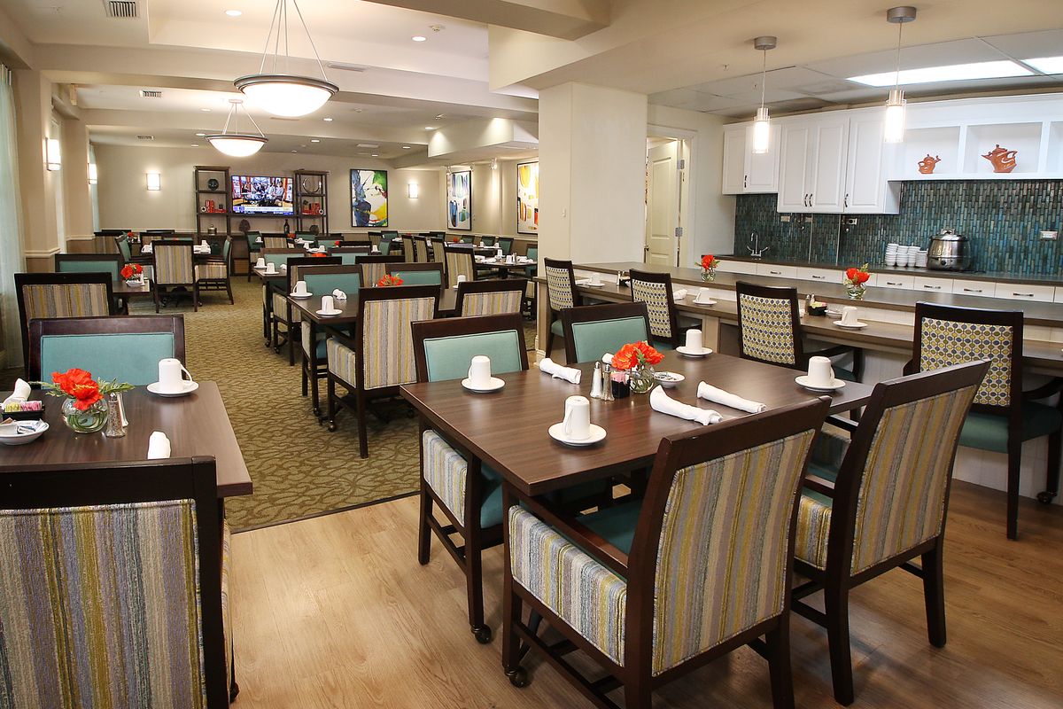 A modern restaurant dining area with neatly arranged tables and chairs, ready for guests.
