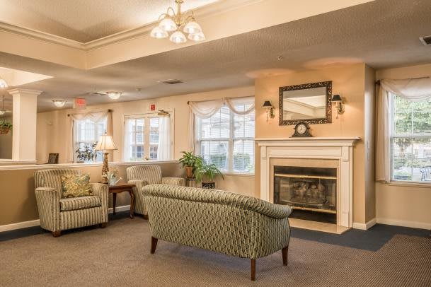 A cozy living room with comfortable seating and a warm fireplace.