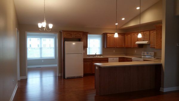Spacious kitchen and dining area with wooden cabinets and an island counter.