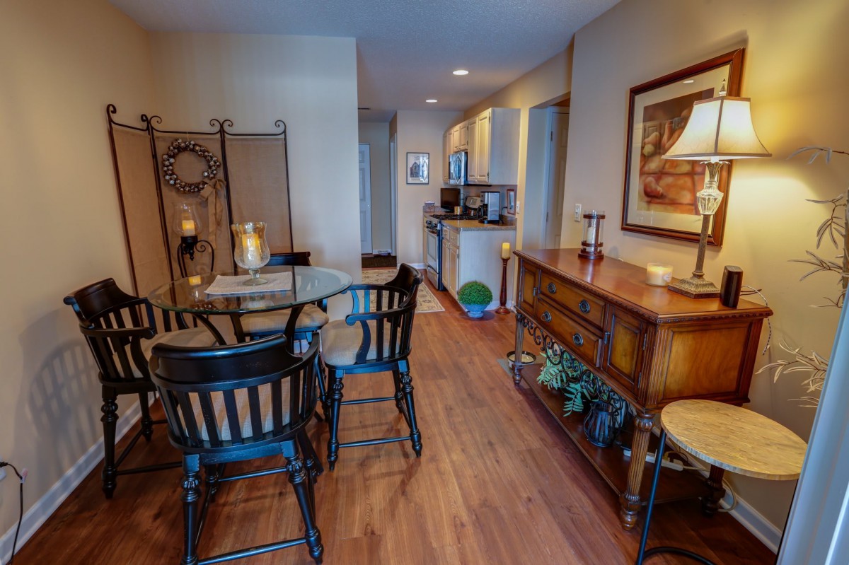 A cozy dining area with warm wooden flooring and inviting ambiance.