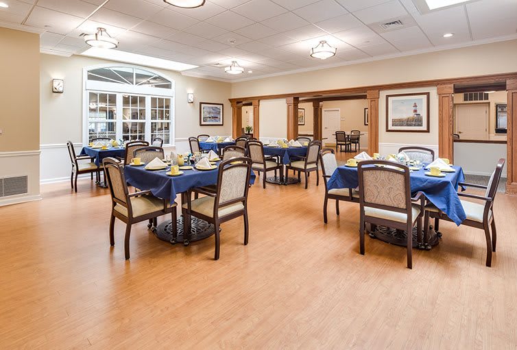 A well-arranged dining room with tables and chairs set for guests.