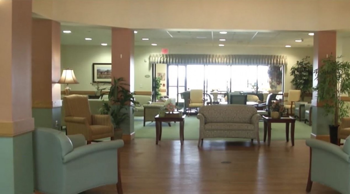 A spacious lobby area featuring comfortable seating and decorative plants.