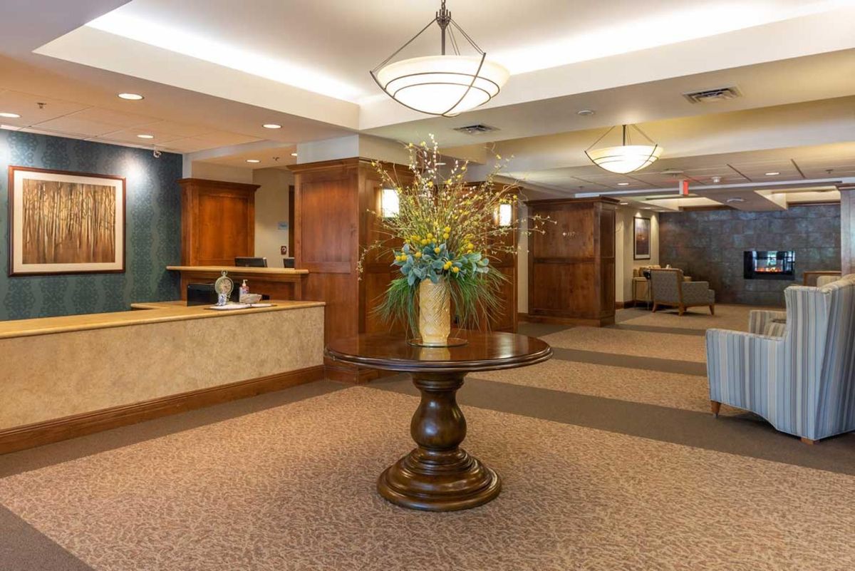 A well-decorated lobby area featuring a central table with a floral arrangement.