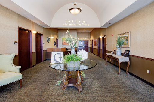 A welcoming lobby featuring elegant furnishings and decorative plants.
