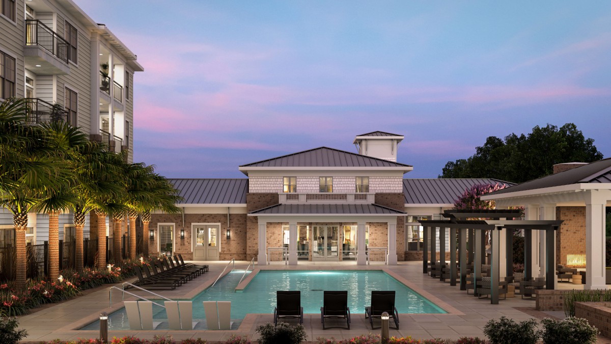 A luxurious residence with a swimming pool at sunset.