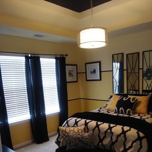A modern bedroom interior with elegant decor and lighting.