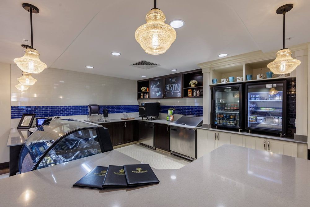 A modern cafe interior with a sleek counter and menu boards.