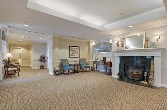 A cozy lobby area with seating, a fireplace, and warm lighting.