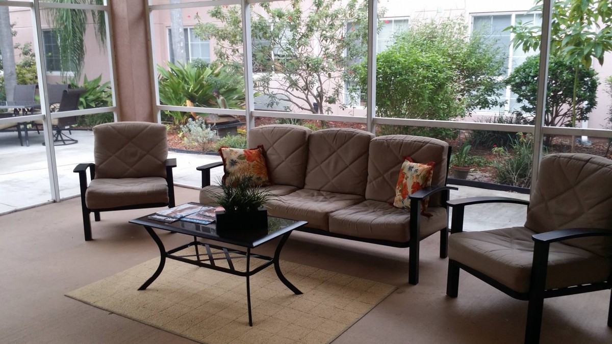 A cozy patio seating area with comfortable furniture and greenery.