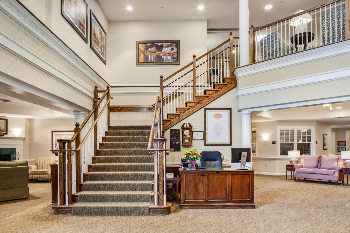 An office lobby with a staircase and reception desk.