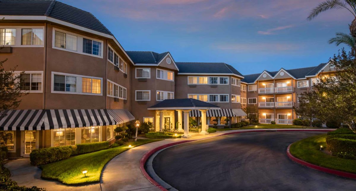 A well-lit residential building exterior at dusk.