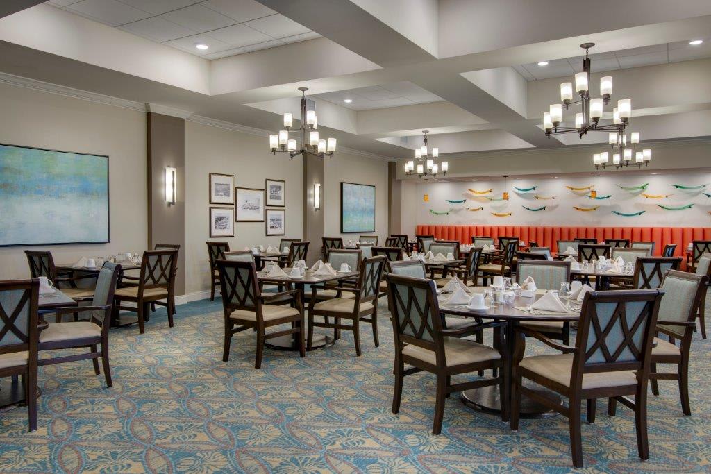 A well-decorated restaurant dining room with neatly arranged tables and chairs.