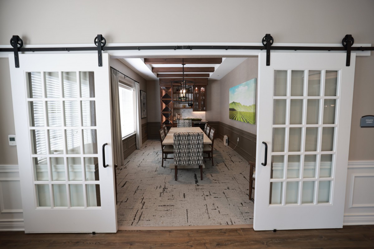 A stylish dining room with sliding doors and modern decor.