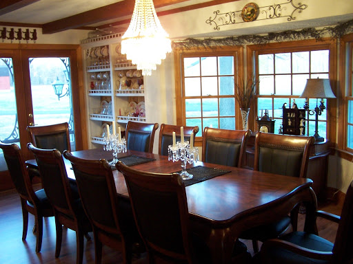 A beautifully arranged dining room featuring a wooden table, elegant chairs, and a stylish chandelier, perfect for family gatherings.