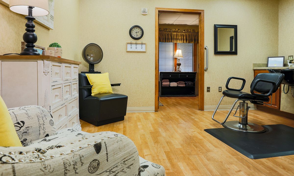 A cozy waiting area with stylish chairs and a wall-mounted clock.