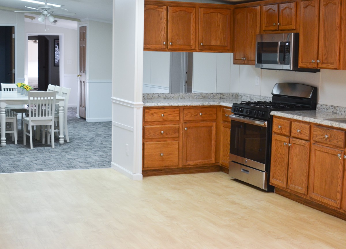 A modern kitchen with wood cabinets and stainless steel appliances.