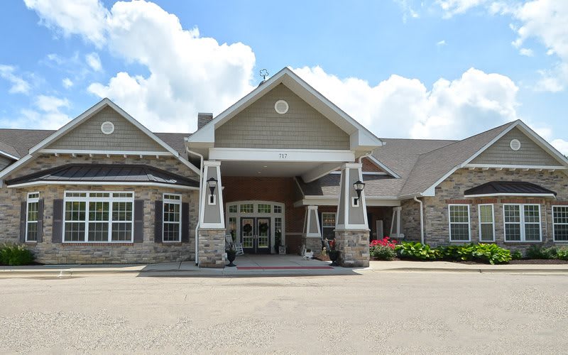 A large residential-style building with a welcoming entrance and stone faade.