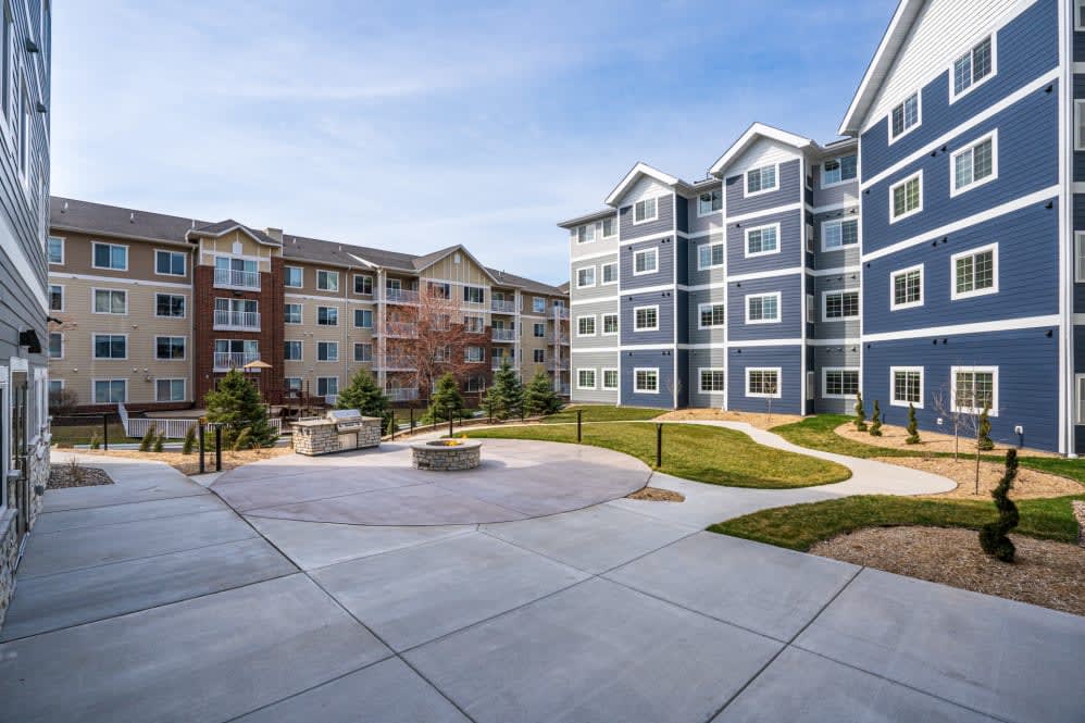 A view of a modern apartment complex with landscaped outdoor space.
