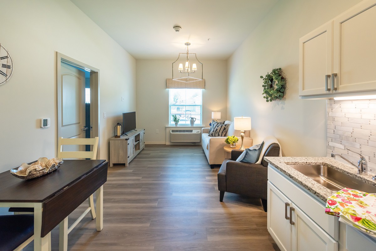 A cozy living room with modern decor and wooden flooring.
