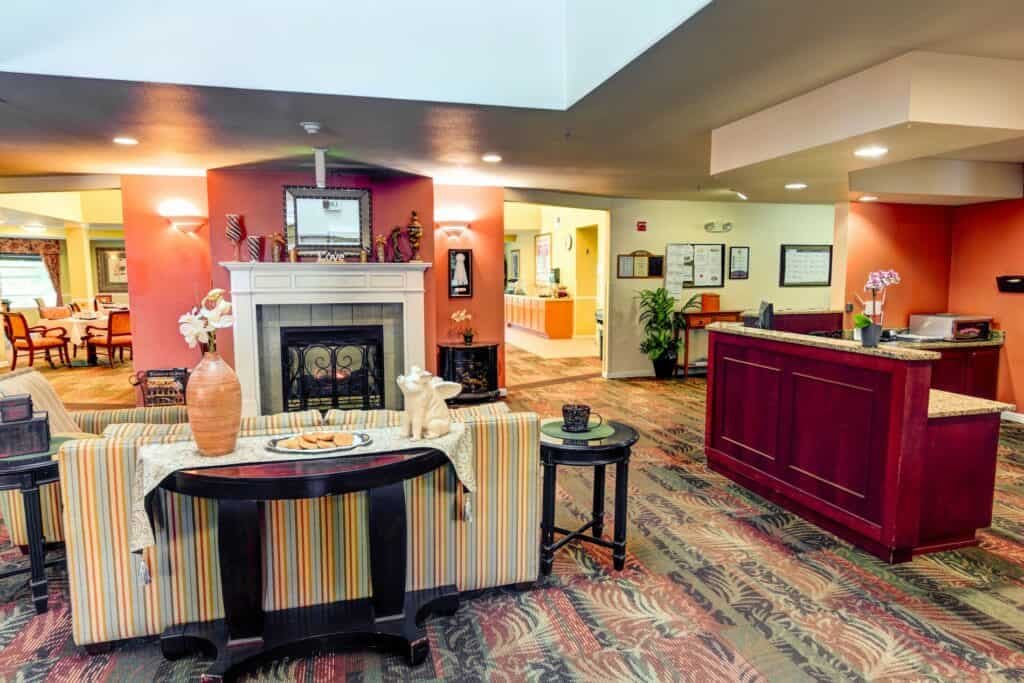 A cozy lobby area with a fireplace, decorative items, and comfortable seating.
