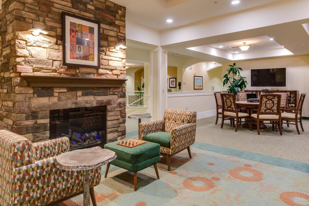 A cozy living room with a fireplace, comfortable seating, and warm decor.
