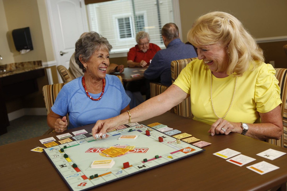 A group of seniors enjoying a board game together.