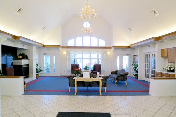 Spacious lobby with elegant furnishings and a chandelier.