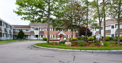 A picturesque residential building surrounded by greenery and landscaping.