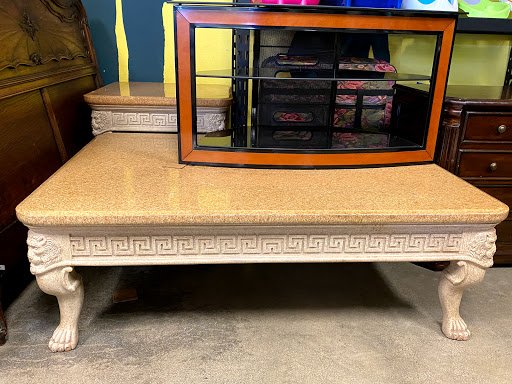 A beautifully designed coffee table featuring a decorative glass top, perfect for any living space.